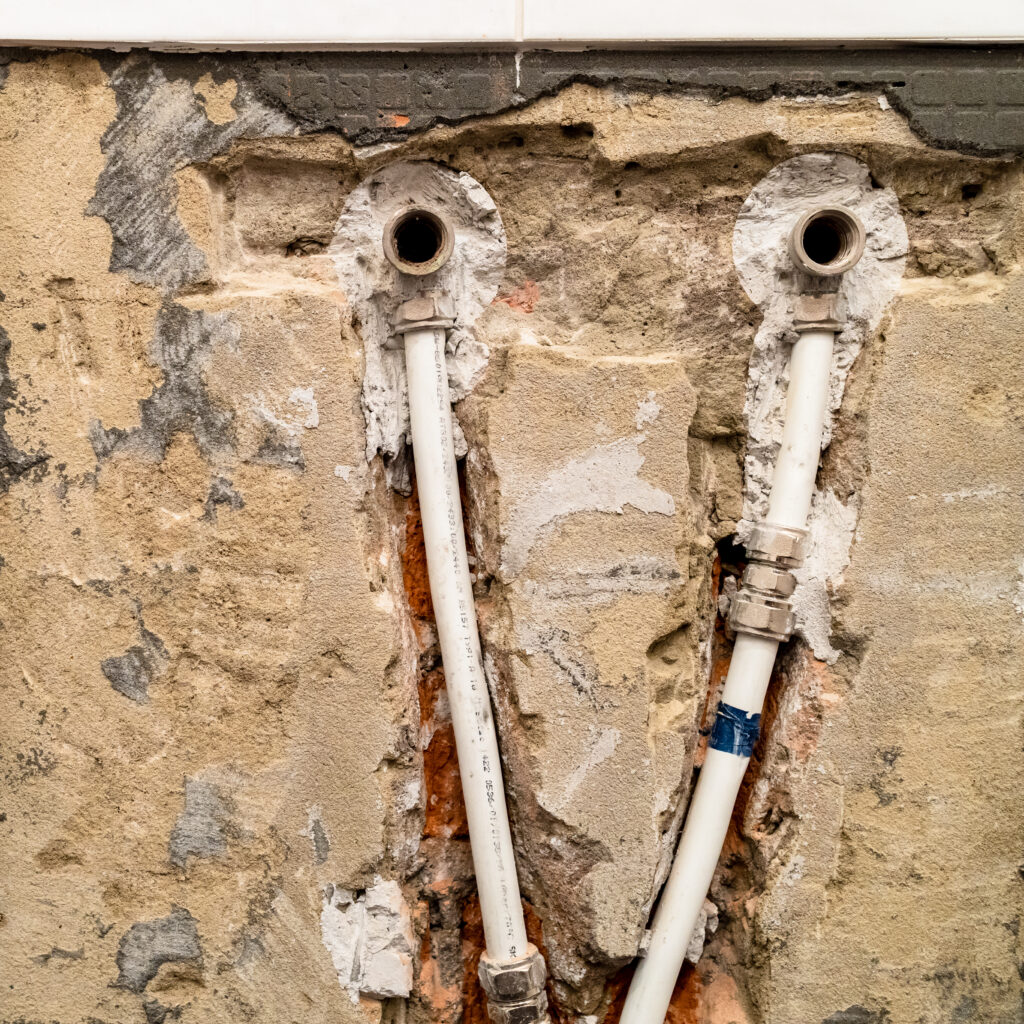 Exposed water pipes in an opened wall