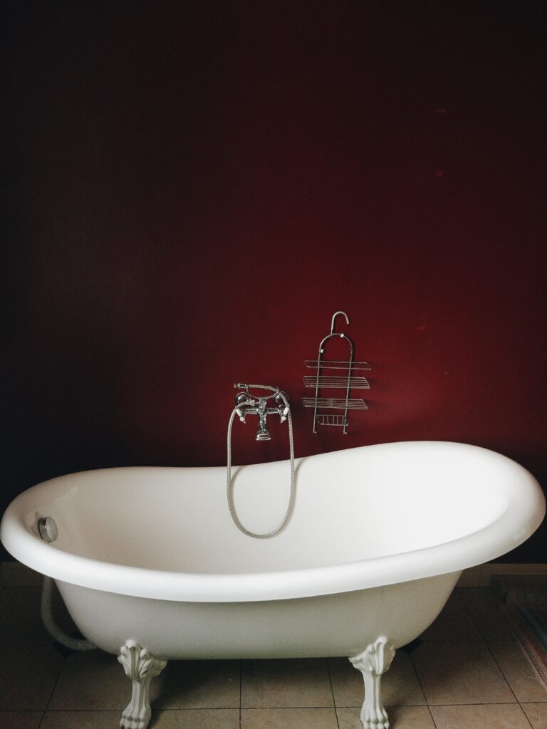 Freestanding roll-top bath with a chrome shower mixer